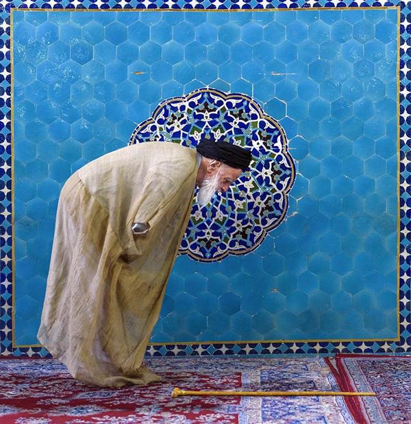 هنر عکاسی عکاسی فرهنگ ایرانی داود ایزدپناه یک روحانی در مقابل طرح شمسی مسجد جامع یزد نماز می خواند
